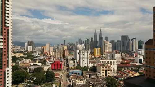 Cityscape against cloudy sky