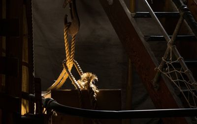 Hook and rope by ladder in ship