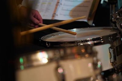 Midsection of person playing piano at music concert