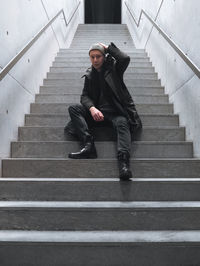 Low angle view of young woman on staircase