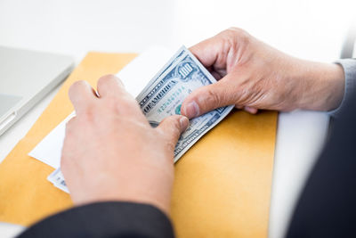 Close-up of woman hand holding paper