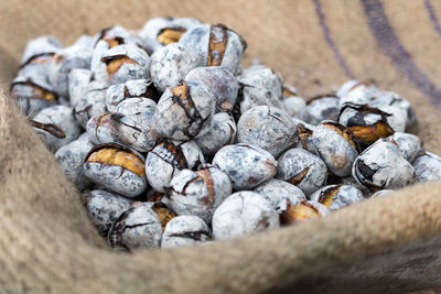 High angle view of roasted chestnuts on sack