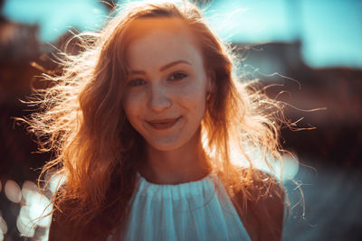 Portrait of smiling young woman standing outdoors