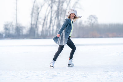 Full length of woman standing on snow