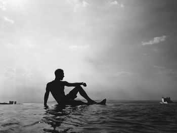 Man sitting in infinity pool