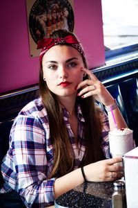 Portrait of young woman in restaurant