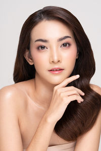 Portrait of a beautiful young woman over white background