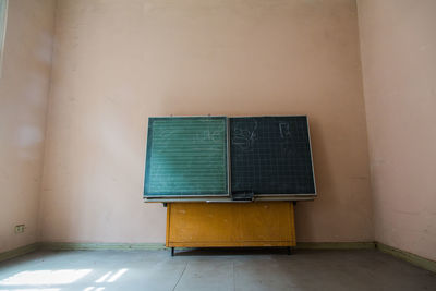 Blackboard against wall in room