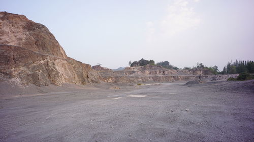 Scenic view of desert road against sky