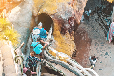 Low angle view of people on rock