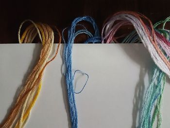 Multi colored threads on table