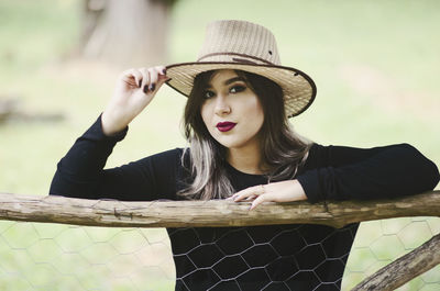 Portrait of beautiful young woman wearing hat