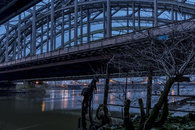 Bridge over river against sky at night