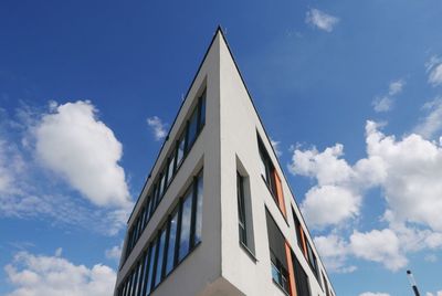 Low angle view of building against cloudy sky