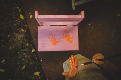 High angle view of hand holding painting