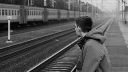 Rear view of man on railroad station platform