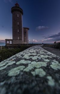 View of lighthouse by sea against sky