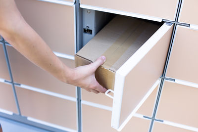Low section of woman standing by railing