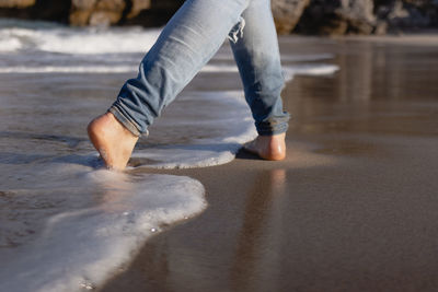 Man walking barefoot on the beach