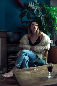 Young woman sitting on table