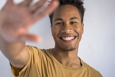 Portrait of smiling young man against white background