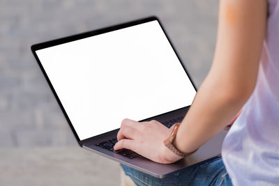 Midsection of woman using mobile phone