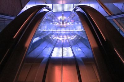 Illuminated reflection on escalator railing