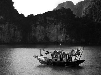 Sailboat on rock by sea