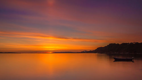 Scenic view of sea against orange sky