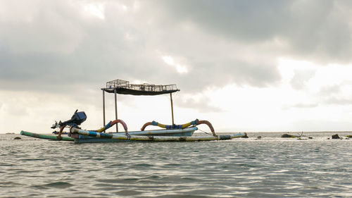 People in boat on sea against sky