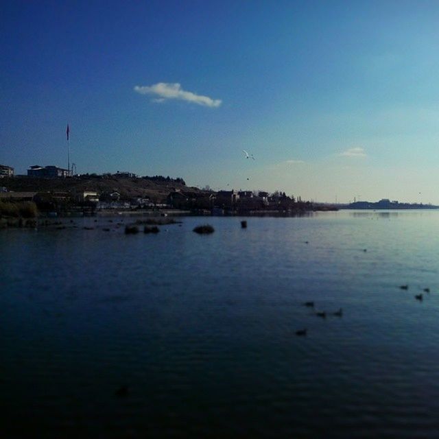 water, blue, sky, tranquil scene, waterfront, tranquility, scenics, reflection, sea, lake, built structure, beauty in nature, nature, building exterior, architecture, river, rippled, calm, outdoors, copy space