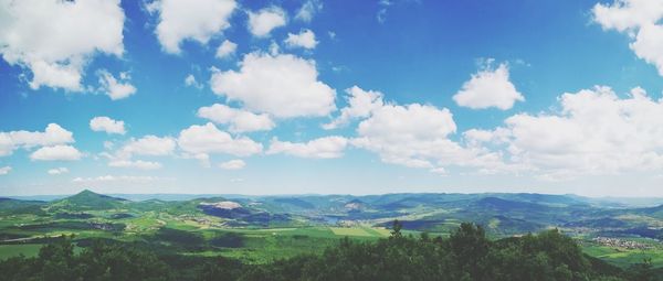 Panoramic view of agricultural field against sky