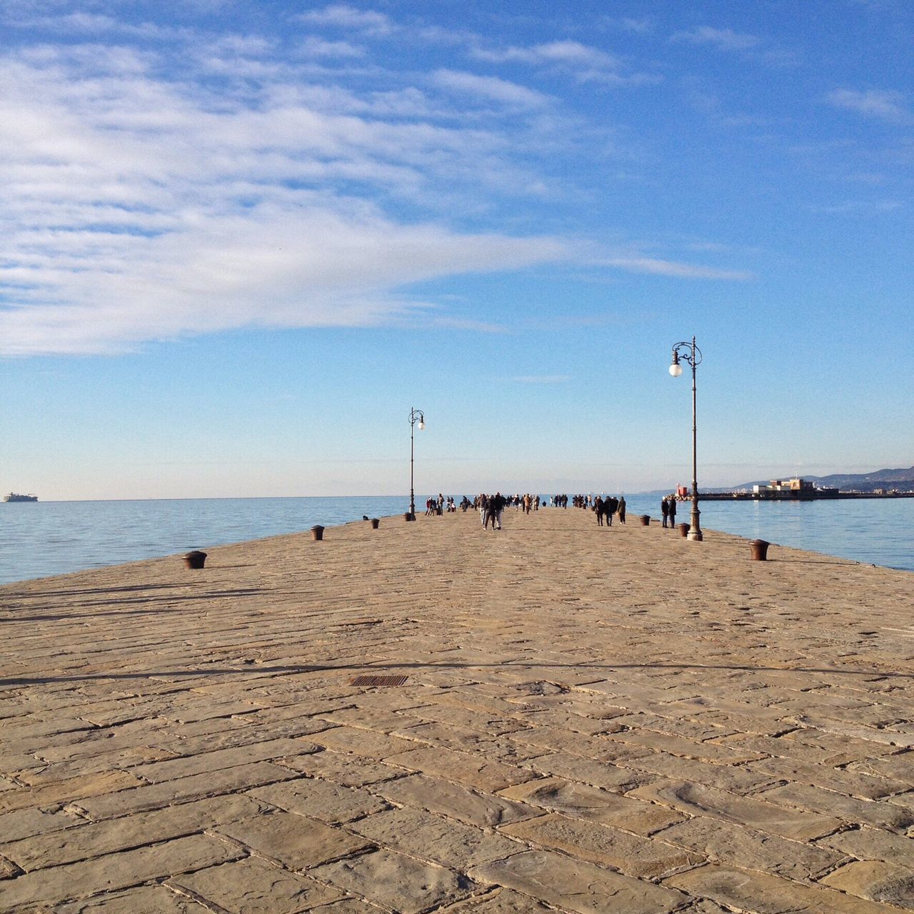 sea, beach, water, sky, sand, horizon over water, shore, tranquil scene, tranquility, the way forward, scenics, incidental people, pier, beauty in nature, nature, cloud - sky, cloud, idyllic, day, outdoors