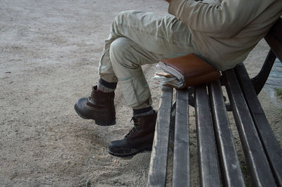 Low section of man sitting outdoors