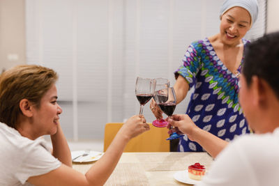 Female friends having food at home