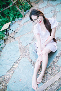 Portrait of a smiling young woman sitting outdoors