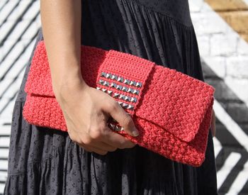 Close-up of woman holding a clutch