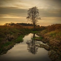 Scenic view of lake against sky during sunset