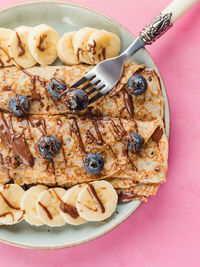 Delicious crepes filled with chocolate hazelnut spread and topped with banana and blueberries