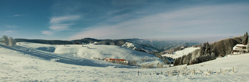 Snow covered landscape against sky