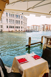 Boats in sea against buildings in city