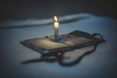 Close-up of lit candles on table