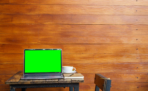 Close-up of laptop on wooden table