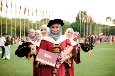 Portrait of people standing on field