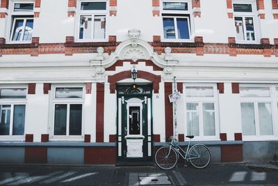 Bicycle parked against residential building