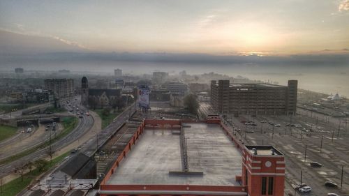 High angle view of parking lot in city against sky in foggy weather