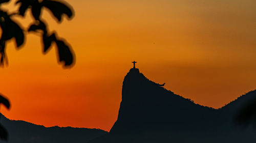 Panorama of cristo redentor at sunset with orange sky