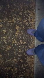 Low section of woman standing on tiled floor