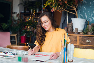 Young woman sitting on table