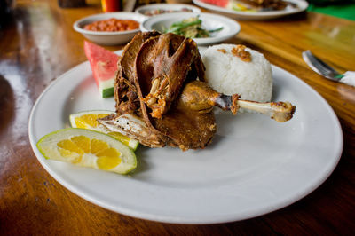 Bebek bengil served in plate on table